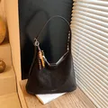 Deep brown matte hobo bag with a decorative beaded charm and BABUMAO branding - With Pendant / Black