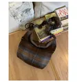 Detail of retro hobo bag with fuzzy plaid texture and stylish ruched strap design - With Pendant / Black and White Plaid