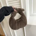 Chic brown faux fur crescent handbag with soft plush texture and trendy knotted handle - Coffee