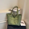 Green checkered nylon tote bag with front flap pocket and sturdy shoulder straps - Green
