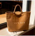 Große braune Totebag aus Wildlederimitat mit weißem Schriftzug und Doppelgriffen - Einheitsgröße / Braun
