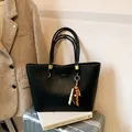 Large black vintage tote bag in textured leather with wooden beaded charm accessory - With Pendant / Black