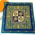 Detailed view of luxury silk scarf featuring golden Baroque floral patterns and blue Greek key - Hand-Rolled Edge / Dark Green