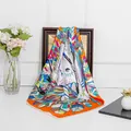 Silk-like square scarf with vibrant feather patterns draped on a wooden frame - Orange Feather (C637) / Orange