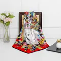 Detailed close-up of a 90cm silk square scarf with colorful feathers and unicorn pattern - Red