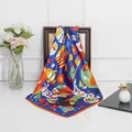 Detail of royal blue silk square scarf with orange borders and cartoon cat print - Sapphire Blue