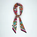 Detail of sunflower silk scarf label showing 100% material and washing instructions - Bright Orange Floral Style (X233-1)