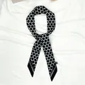 Detail of black and white geometric pattern twilly silk scarf with pointed ends and care label - Black and White Geometric Grid (X232-4)