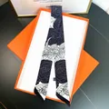 Close-up of black and white camellia silk scarf twilly in luxury orange gift box - Gray And Black Camellia Style (C201-3)