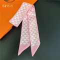 Macro detail of a pink geometric silk twilly scarf with sharp pointed edges on dark background - Pink/White (C211-1)