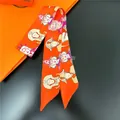 Silk-like polyester twilly scarf with colorful portrait prints and orange background - Bright Orange (C231-2)
