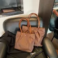 Dark brown waterproof nylon tote bags in two sizes with sleek leather handles - Coffee