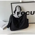 Black nylon crossbody bag with wide adjustable strap and large capacity design - One Size / Black