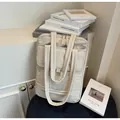 Off-white quilted large capacity commuter shoulder bag with multiple pockets and long straps - One Size / Off White