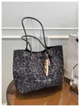 Close-up of leopard print felt tote bag with ethnic wood bead pendant on a table - With Pendant / Gray