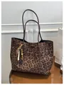 Leopard print tote bag with brown leather straps and wooden bead charm on mirror table - With Pendant / Brown