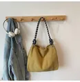 Mustard yellow corduroy tote bag featuring a black and white checkered woven strap - Yellow