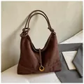 Close-up of brown faux suede hobo bag featuring a decorative knot and golden hardware - Coffee without Pendant