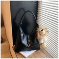 Black suede hobo shoulder bag with golden ring buckle and lion plush charm decoration - With Pendant / Black