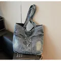 Washed blue denim tote bag with double zipper pockets and center drawstring detail - One Size / Blue Denim