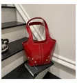 Red patent leather tote bag with silver studs and metal eyelets on top handles - Red
