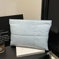 Light blue quilted puffer laptop sleeve bag with magnetic closure in minimalist style - Blue / One Size