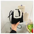 Mini black suede dumpling bag with white faux fur trim and leather crossbody strap - One Size / Black