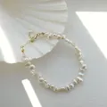 Detail of baroque freshwater pearl necklace with golden clasp on a white shell - Necklace Style C / 38cm+5cm