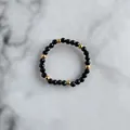 Detail of beaded ring with faceted black stones and golden accents on marble surface - Black Faceted Beads Style (A Ring)