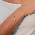Detailed close-up of a 18k gold plated necklace with small natural freshwater pearls - Bracelet - Style 3