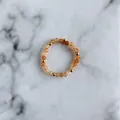 Macro detail of handmade beaded ring with orange natural stones and gold metal spacers - Orange Polyhedral Beads Style (C Ring)
