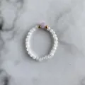 Close-up of beaded ring with white crystal beads and a center lavender gemstone - Translucent White Beads with Light Purple Main Bead Style (K Ring)