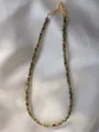 Detailed macro view of handmade colorful natural stone beads with gold plated chain - Necklace / 38+5cm / Olive Green Spotted