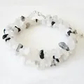 Detail of double-layer necklace with white and black natural stones on marble surface - Black and White Mixed Chips (Style D) / Steel