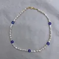 Detail of baroque pearl necklace with blue evil eye beads and golden lobster clasp - Style F / One Size / 38+5cm / White/Navy Blue