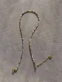 Detail of beaded necklace with gold heart pendant and lobster clasp on grey fabric - One Size / Earth Tone Mixed Style (8 Necklaces)