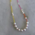 Bohemian style freshwater pearl necklace with colorful beads on a marble background - Short Choker Length / Pink Yellow Orange