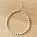 Freshwater pearl necklace with green beads and gold lobster clasp on wood background - Short Choker Length / Green
