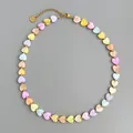 Detailed view of heart-shaped shell beads on a 18k gold plated stainless steel chain - Gold-Spaced Macaron Colorful Shell Necklace / 38+5cm