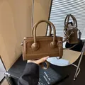 Structured brown crossbody bag in leather patchwork with leopard-print style round decor - Brown