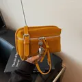 Mustard yellow faux suede fanny pack with retro silver robot charm and zipper detail - Yellow