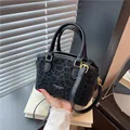 Elegant black crossbody handbag with leopard texture and gold hardware detail - With Pendant / Black Leopard Style