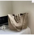 Large khaki canvas tote bag with pleated texture, showing detachable wide shoulder strap - Khaki