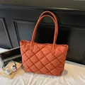 Quilted tote bag in bright orange featuring diamond stitching and long shoulder straps - Orange