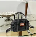 Detailed close-up of a black denim mini Boston bag with white stitching and silver hardware - One Size / Black