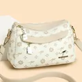 Borsa a tracolla crema con stampa floreale, logo dorato e scomparti con cerniera multipli - Taglia unica / Bianco Riso Con Albicocca