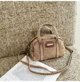 Detail of vintage denim Boston bag featuring brown leather logo plate and double handles - One Size / Khaki
