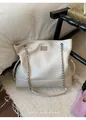 Detail of cream white leather tote bag featuring braided chain straps and drawstrings - With Pendant / White
