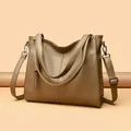 Detail of khaki leather tote bag featuring fine lychee texture and metallic strap hardware - One Size / Elephant Grey
