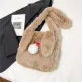 Süße aprikosenfarbene Plüschtasche mit weichen Hasenohren und weißem Bommel-Anhänger - Khaki